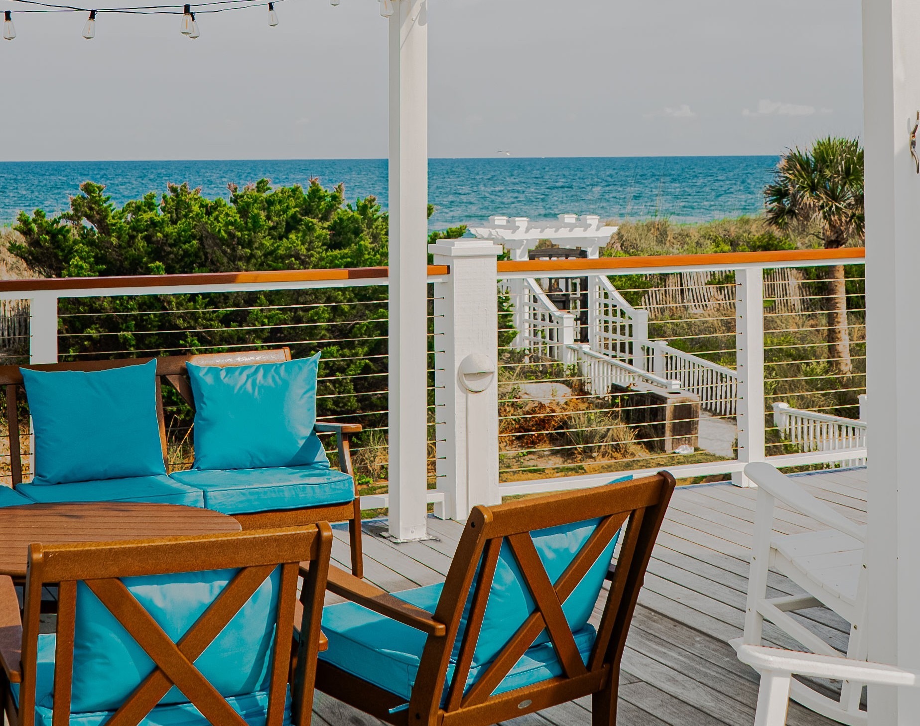 The Surf Club oceanfront deck lounge with turquoise cushions and ocean views