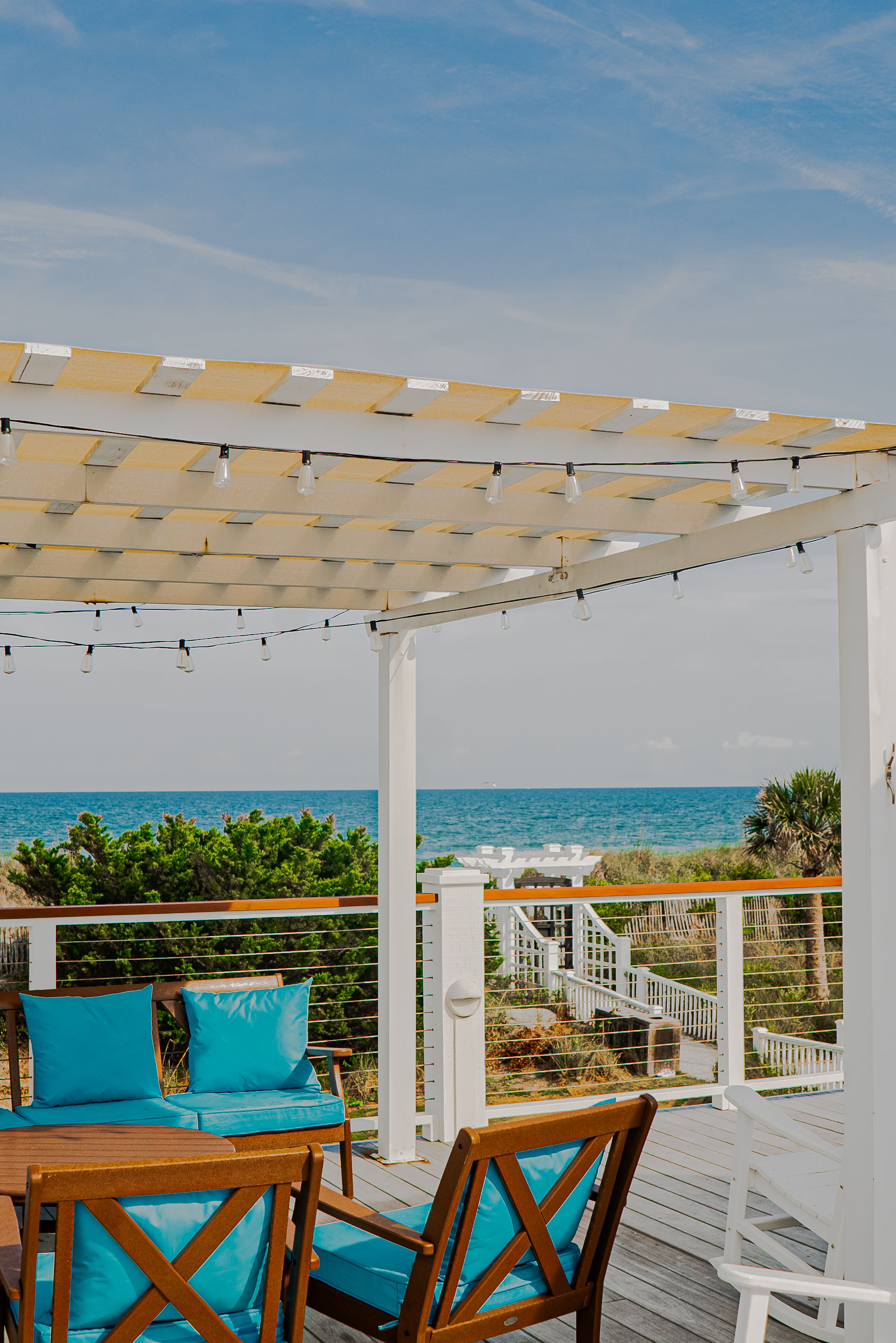 The oceanfront deck lounge under the pergola at The Surf Club