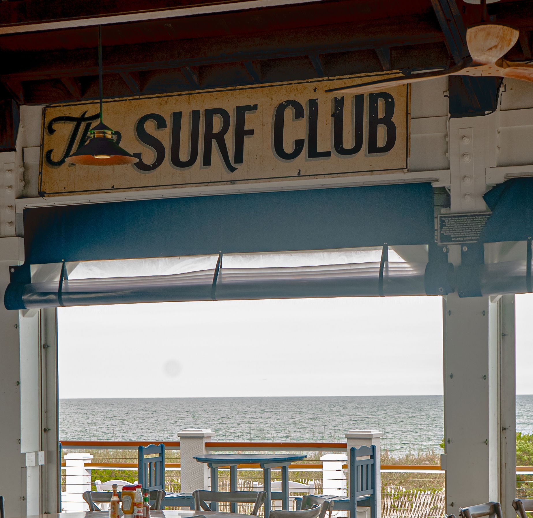 A table set at The Surf Club, open to the ocean