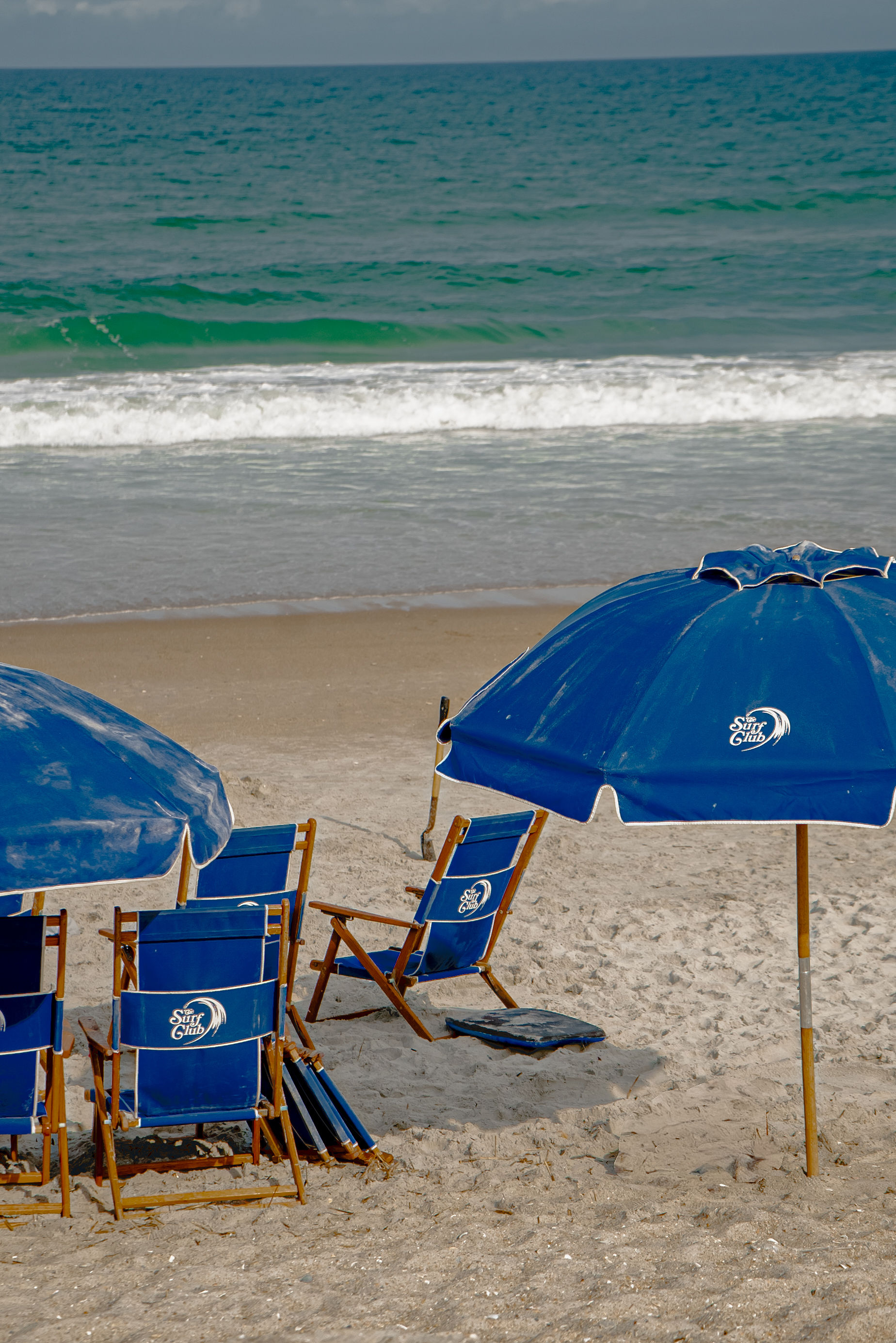 Blue Surf Club umbrellas and chairs on the sand